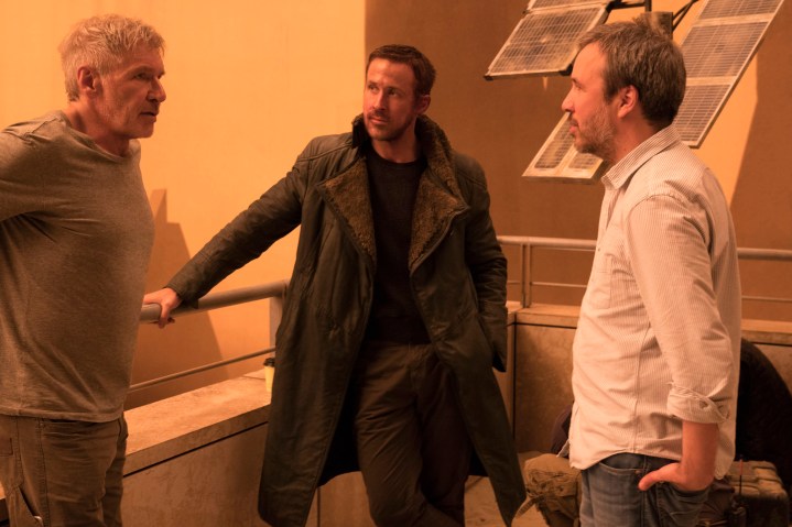 Dennis Villainyuway Blade Runner stands on the set of 2049 with Harrison Ford and Ryan Gosling.