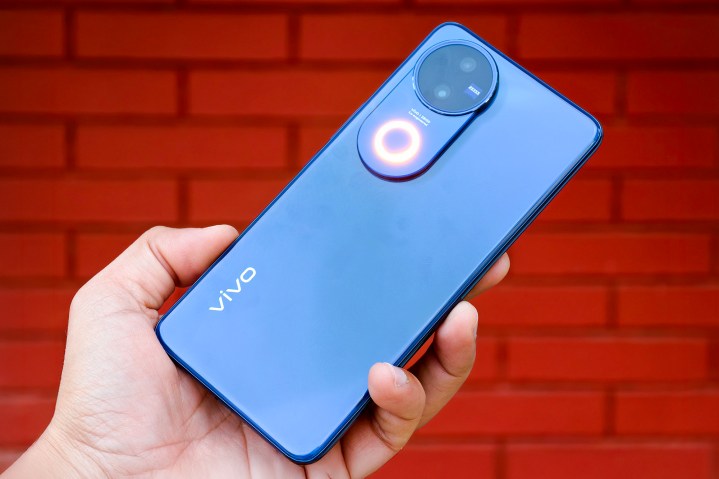I’ve tested the best camera phone for $400 3 Vivo V50 celestial blue with Aura Light held in hand.
