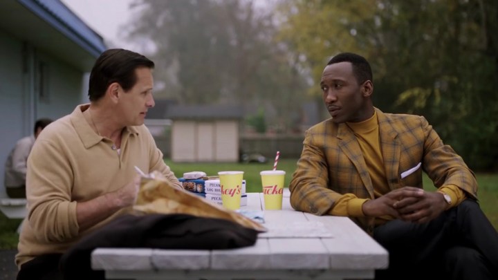 7 greatest Oscars Snowbas of last 10 years, rank 7 Two men sit on a picnic table outside of eating and talking in a scene of the green book.